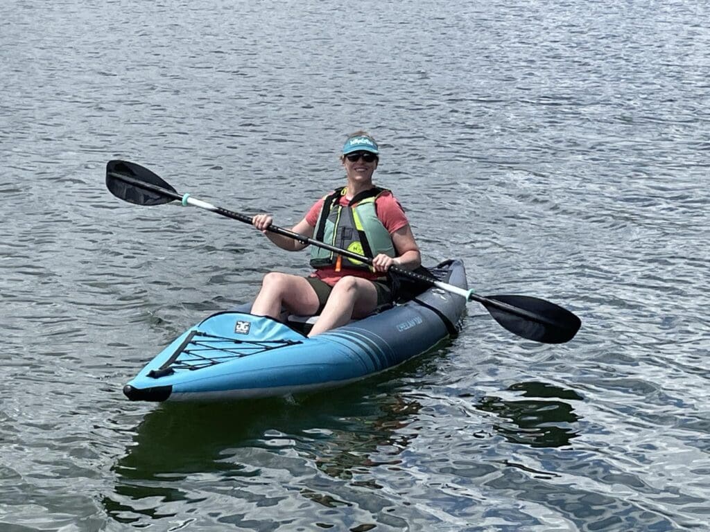 Denise Baum outside in a kayak.